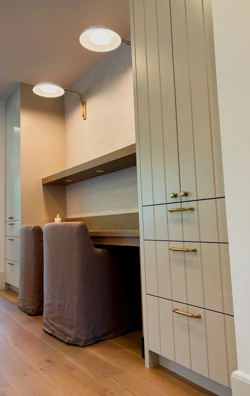 Swick Road home office built-in — floating desk with floor-to-ceiling cabinetry and brass hardware