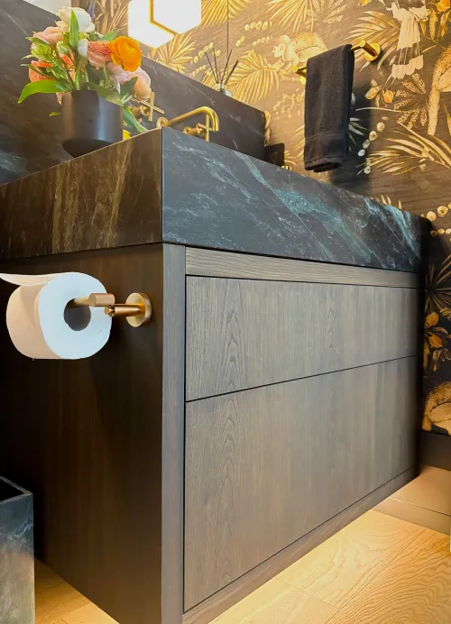 Swick Road powder room — floating dark oak vanity with black marble counter and dramatic wallpaper
